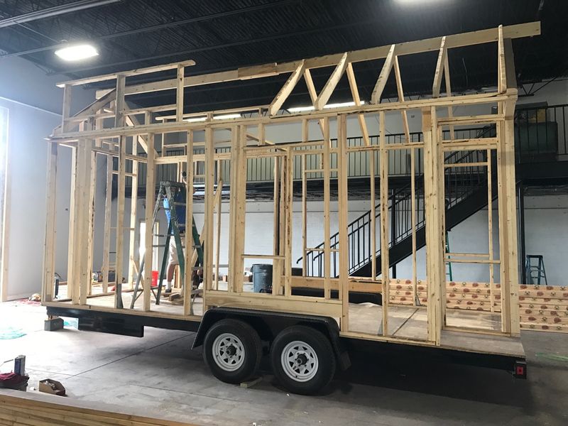 Wall framing going up on a 20-ft tandem-axle trailer