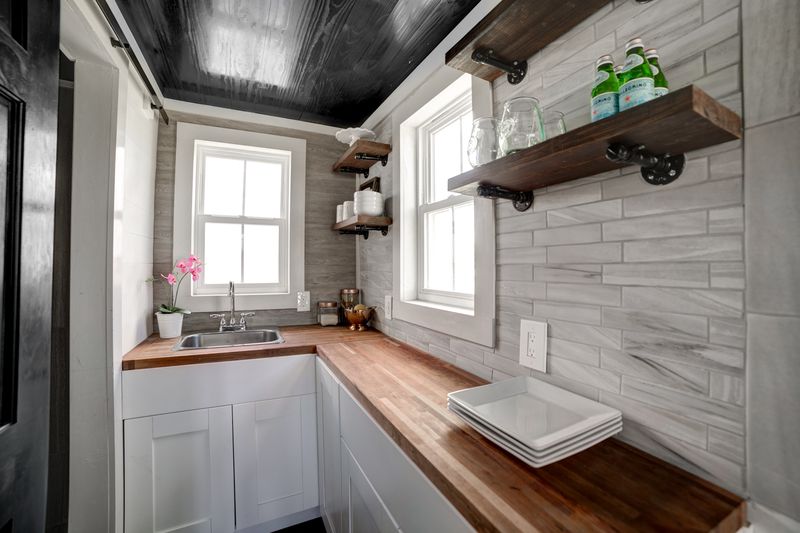 Butcher-block counter and pipe-bracket open shelves
